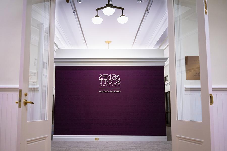 Entrance to the admission office- a purple wall reads "Agnes Scott College"